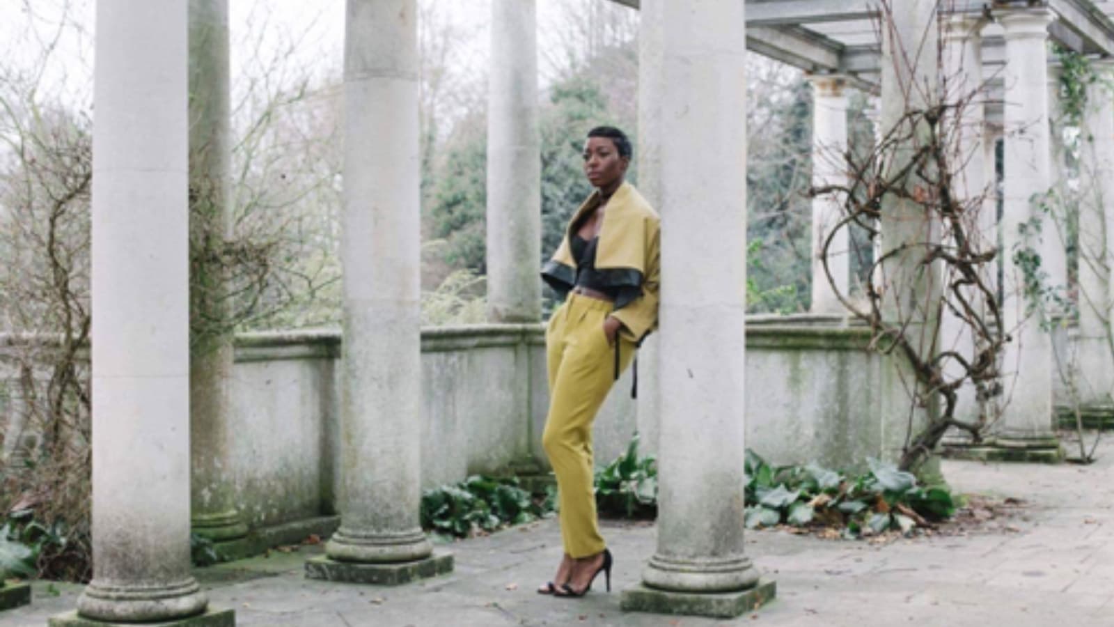 Szjerdene, the famous British band, Bonobo’s singer standing at ancient pillar in Budapest shopping tour.